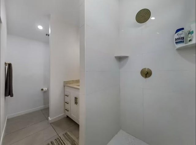 bathroom with tile patterned floors, vanity, and walk in shower