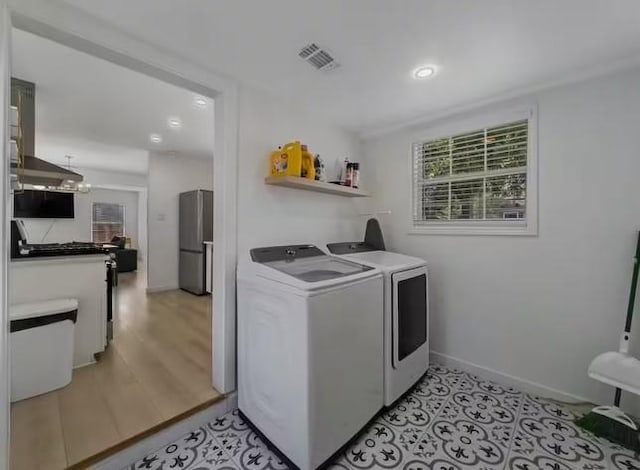 clothes washing area featuring washer and dryer