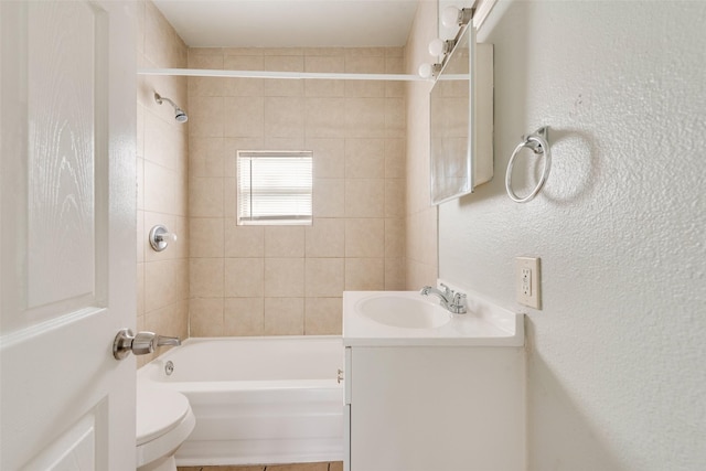 full bathroom with vanity, toilet, and tiled shower / bath combo