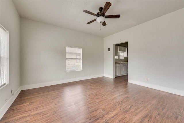 unfurnished room featuring a textured ceiling, dark hardwood / wood-style floors, and ceiling fan