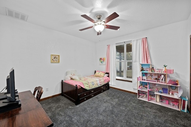 bedroom featuring ceiling fan and dark carpet