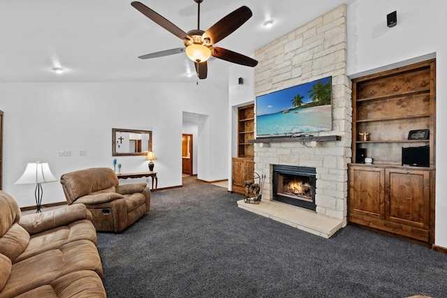 carpeted living room with built in features, a fireplace, high vaulted ceiling, and ceiling fan