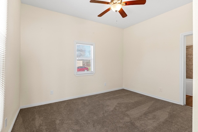 empty room featuring ceiling fan and dark colored carpet