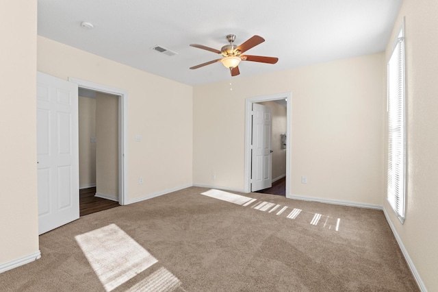 unfurnished bedroom featuring ceiling fan and carpet