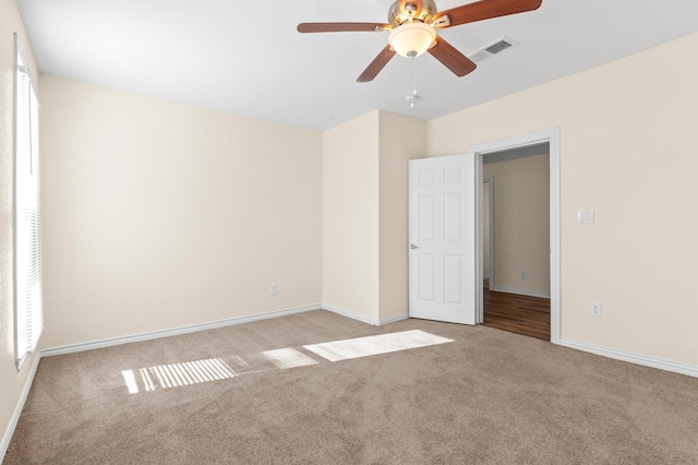 empty room with light colored carpet and ceiling fan