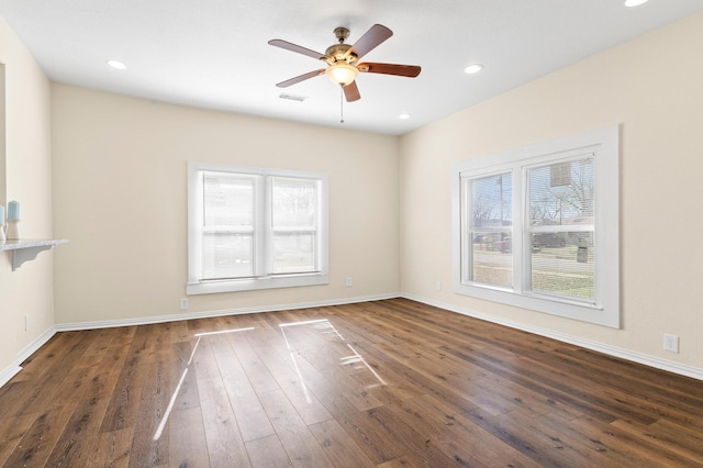 spare room with plenty of natural light, dark hardwood / wood-style floors, and ceiling fan