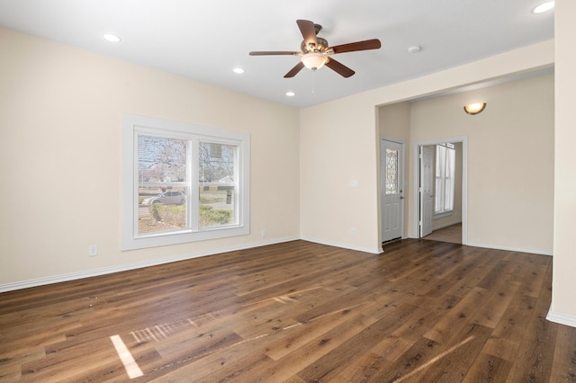 spare room featuring ceiling fan and dark hardwood / wood-style flooring