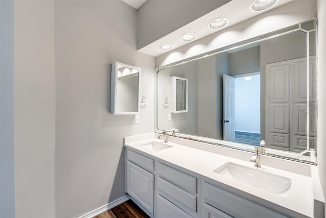 bathroom with vanity and hardwood / wood-style flooring