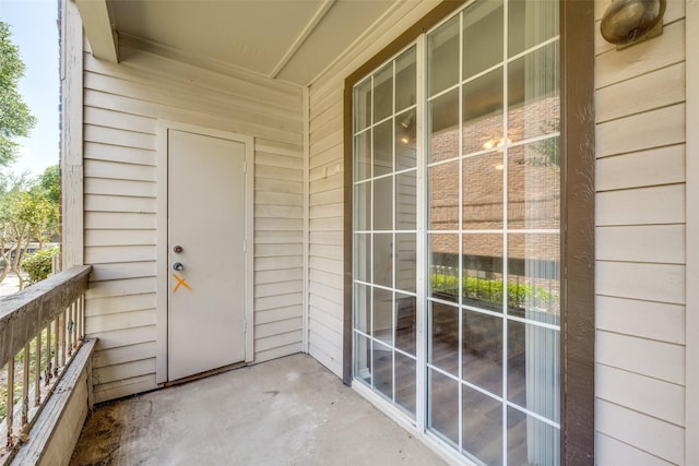 view of exterior entry featuring a balcony