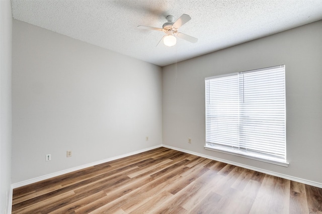 empty room featuring a textured ceiling, ceiling fan, and light hardwood / wood-style flooring