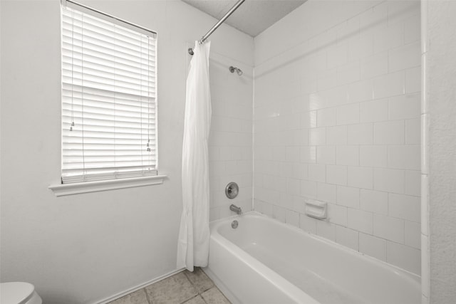 bathroom with tile patterned floors, shower / bath combo, toilet, and a textured ceiling