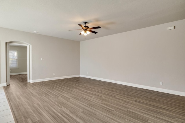 unfurnished room with ceiling fan and dark hardwood / wood-style floors