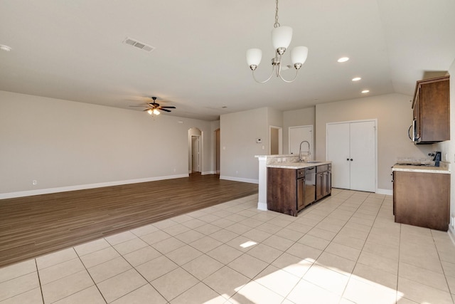 kitchen featuring decorative light fixtures, sink, light tile patterned floors, and ceiling fan with notable chandelier