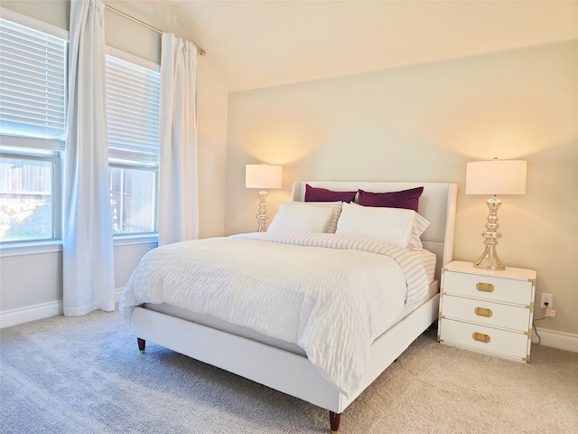 bedroom featuring light colored carpet