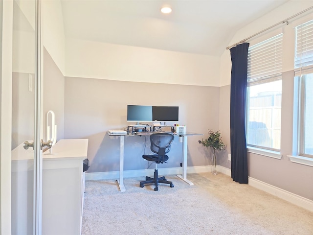 office area featuring a healthy amount of sunlight, light colored carpet, and lofted ceiling