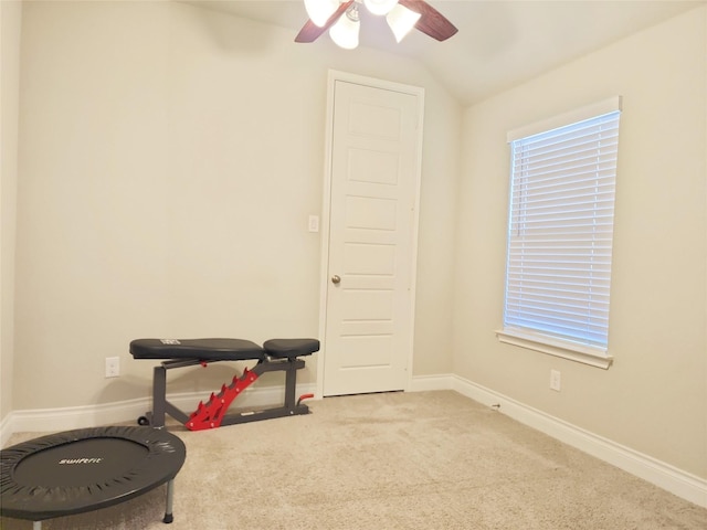 workout room with ceiling fan, carpet floors, and lofted ceiling