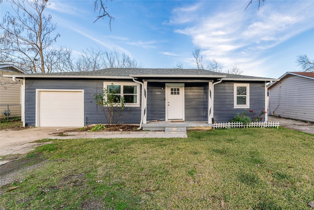 ranch-style house featuring a garage and a front lawn