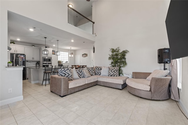 living room featuring a high ceiling and light tile patterned floors