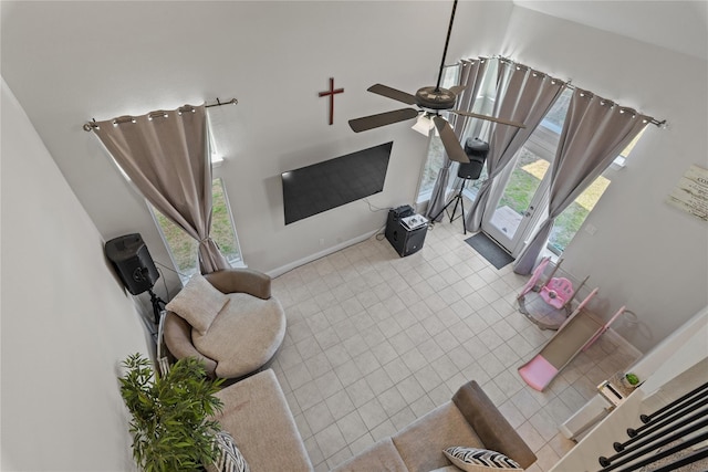 tiled living room featuring a healthy amount of sunlight and ceiling fan