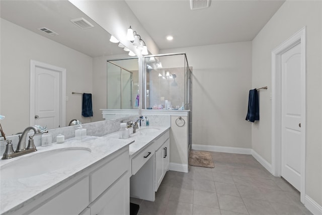 bathroom featuring tile patterned floors, vanity, and a shower with door