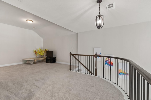 additional living space featuring vaulted ceiling and carpet