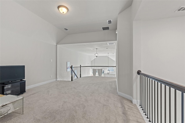 interior space featuring carpet floors and vaulted ceiling