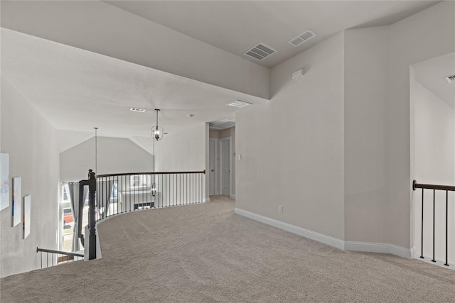 empty room with lofted ceiling and carpet floors