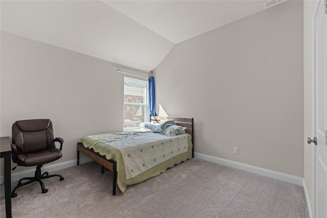 carpeted bedroom with vaulted ceiling