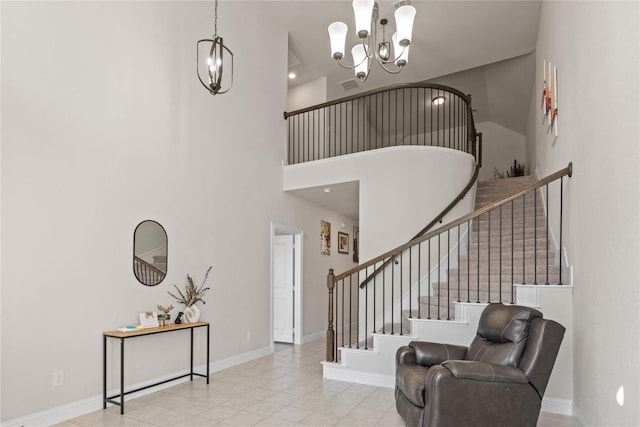 tiled entrance foyer featuring a high ceiling and an inviting chandelier