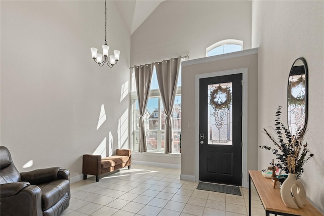 tiled foyer with a high ceiling and a chandelier