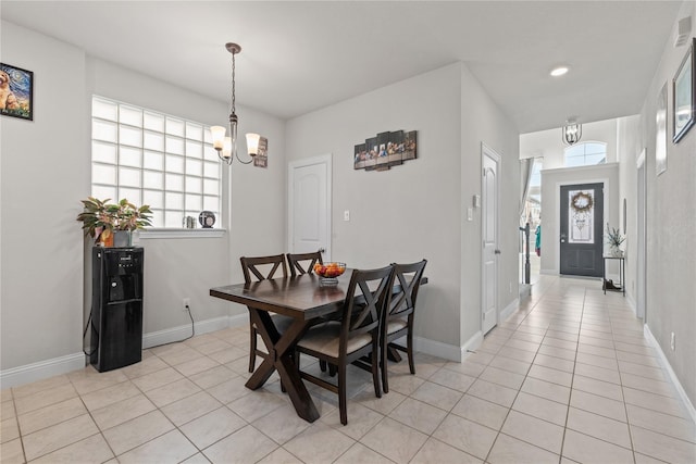 tiled dining area with an inviting chandelier