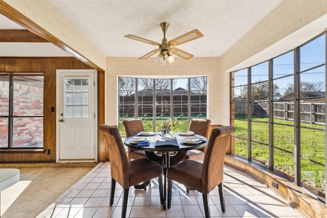 sunroom with ceiling fan and plenty of natural light