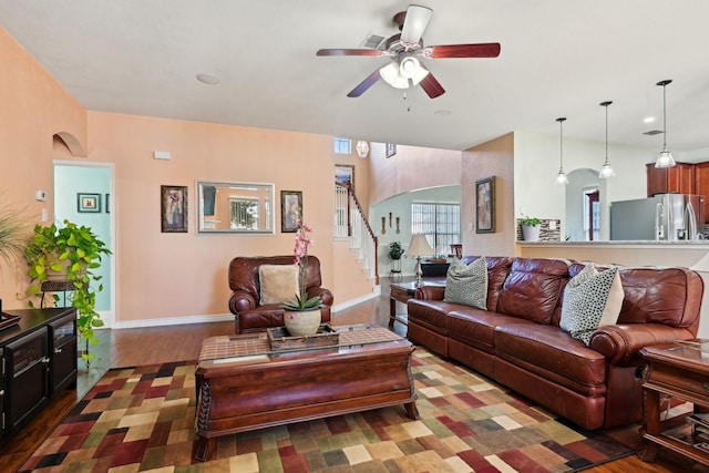 living room featuring dark hardwood / wood-style floors and ceiling fan