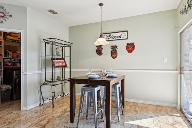 dining space featuring washer / dryer