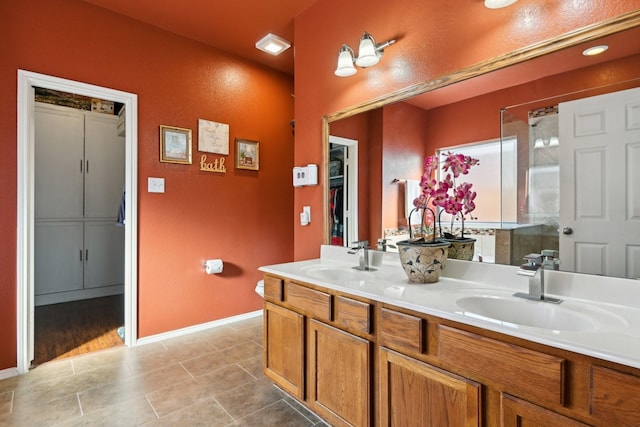 bathroom featuring vanity, an enclosed shower, and tile patterned flooring