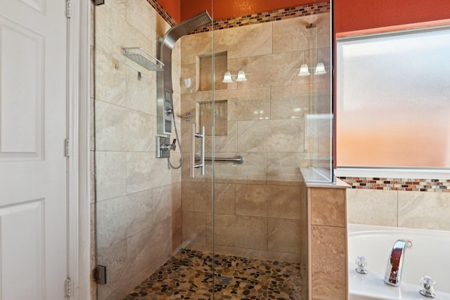 bathroom featuring independent shower and bath