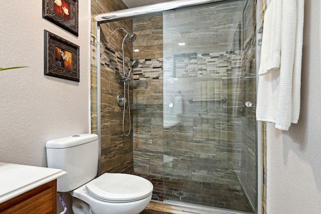 bathroom with vanity, an enclosed shower, and toilet