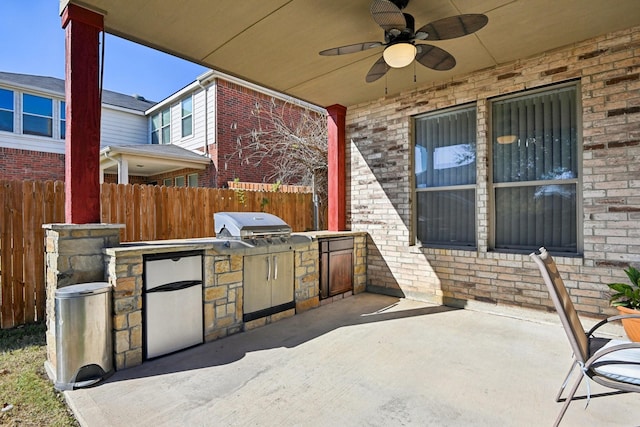 view of patio / terrace featuring a grill, ceiling fan, and exterior kitchen