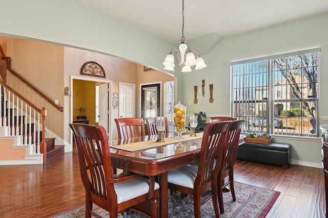 dining area featuring an inviting chandelier and dark wood-type flooring