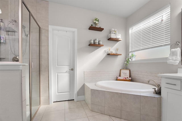 bathroom with tile patterned floors, separate shower and tub, and vanity