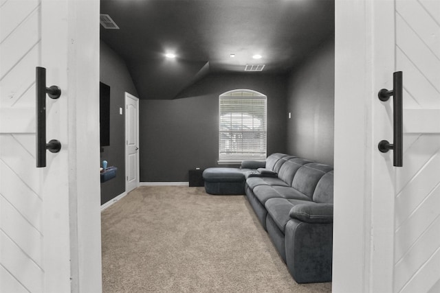 carpeted home theater room with lofted ceiling