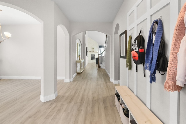 mudroom featuring light hardwood / wood-style floors and a notable chandelier