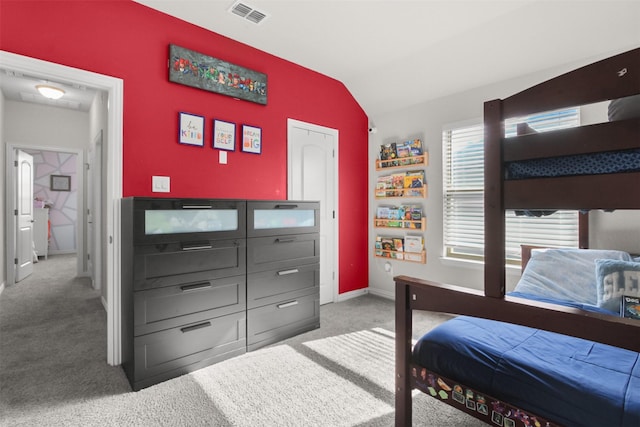 bedroom featuring vaulted ceiling and carpet