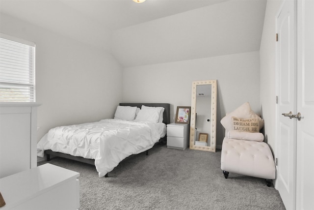 carpeted bedroom featuring vaulted ceiling