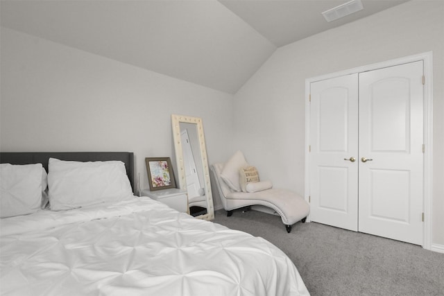 bedroom with carpet, a closet, and lofted ceiling