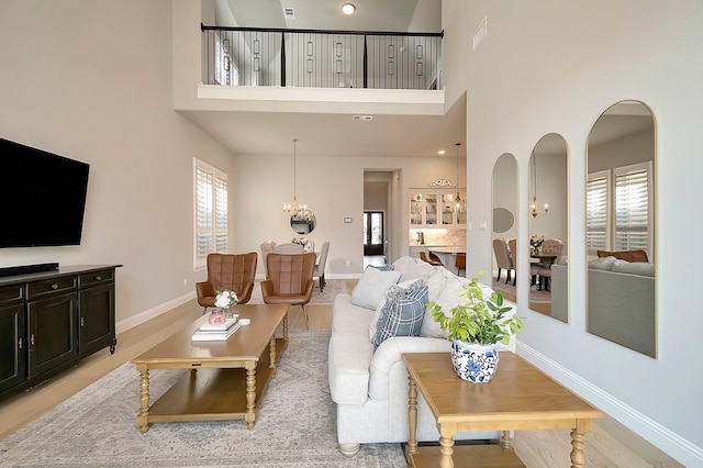 living room with a high ceiling and a notable chandelier