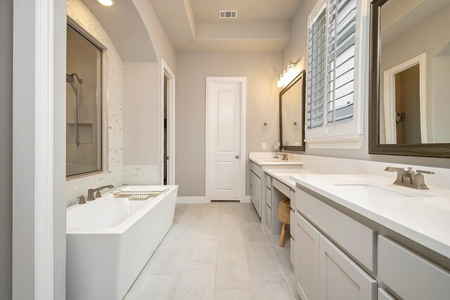 bathroom with tile patterned flooring, vanity, and shower with separate bathtub