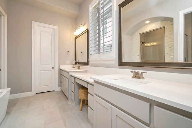 bathroom with tile patterned floors, vanity, and walk in shower