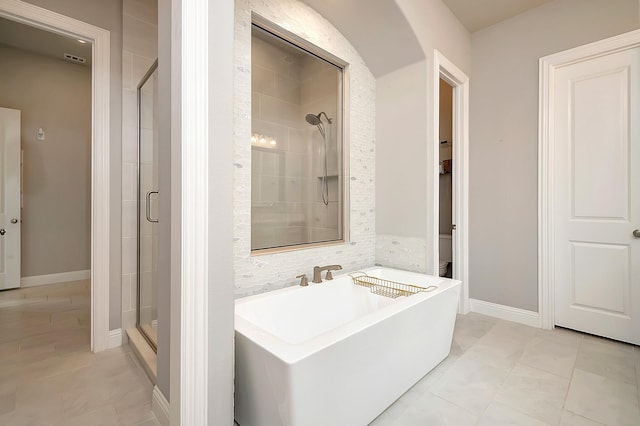 bathroom with tile patterned flooring and a shower with shower door