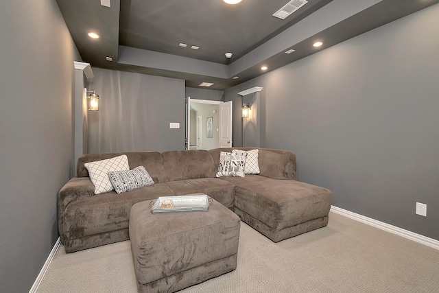 carpeted home theater room with a raised ceiling